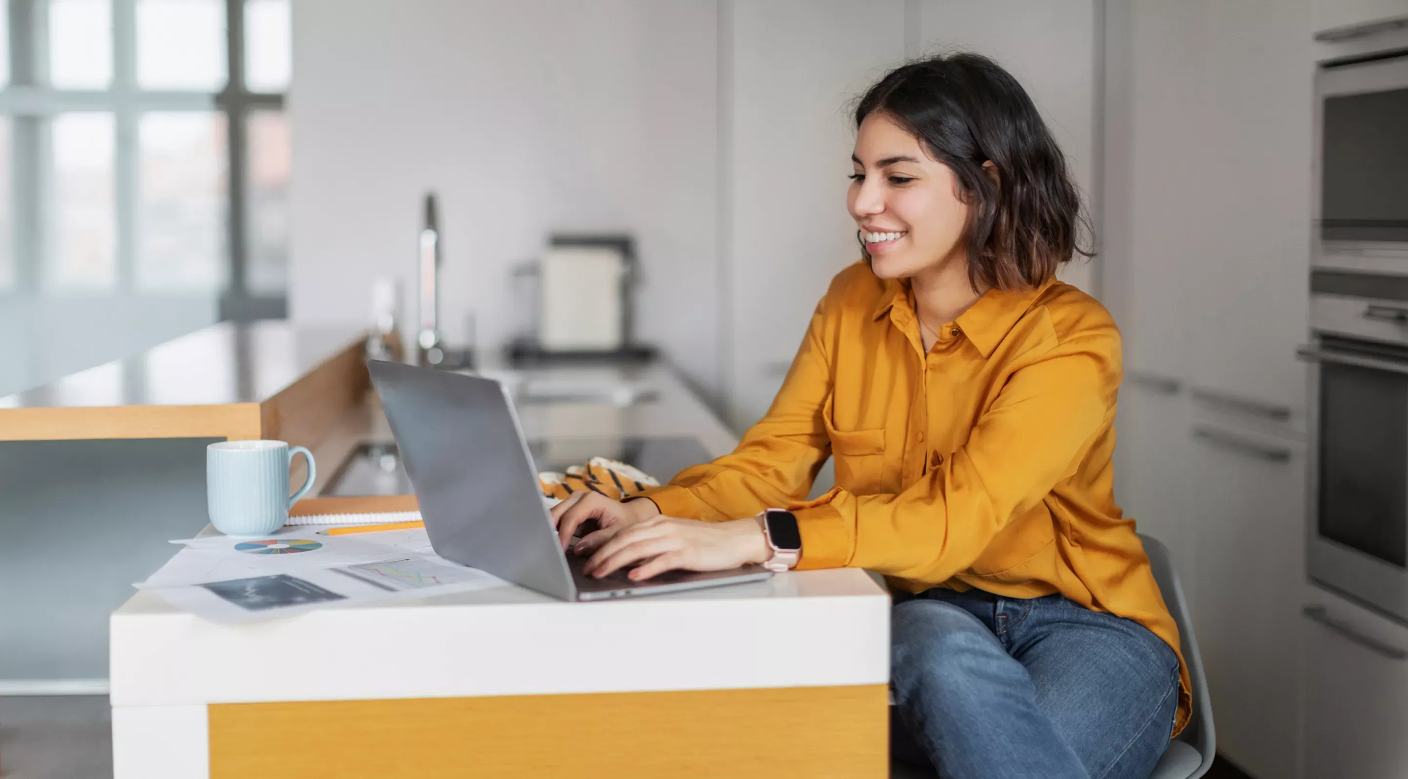 Happy woman wearing orange works from home with fast internet
