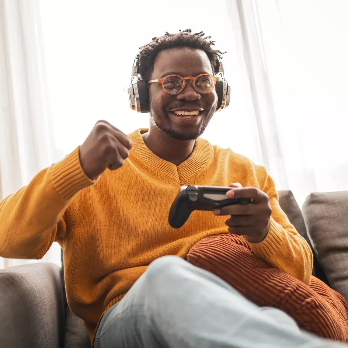 Happy man gaming at home