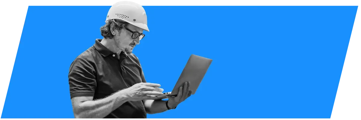 IT professional in a hard hat with a laptop