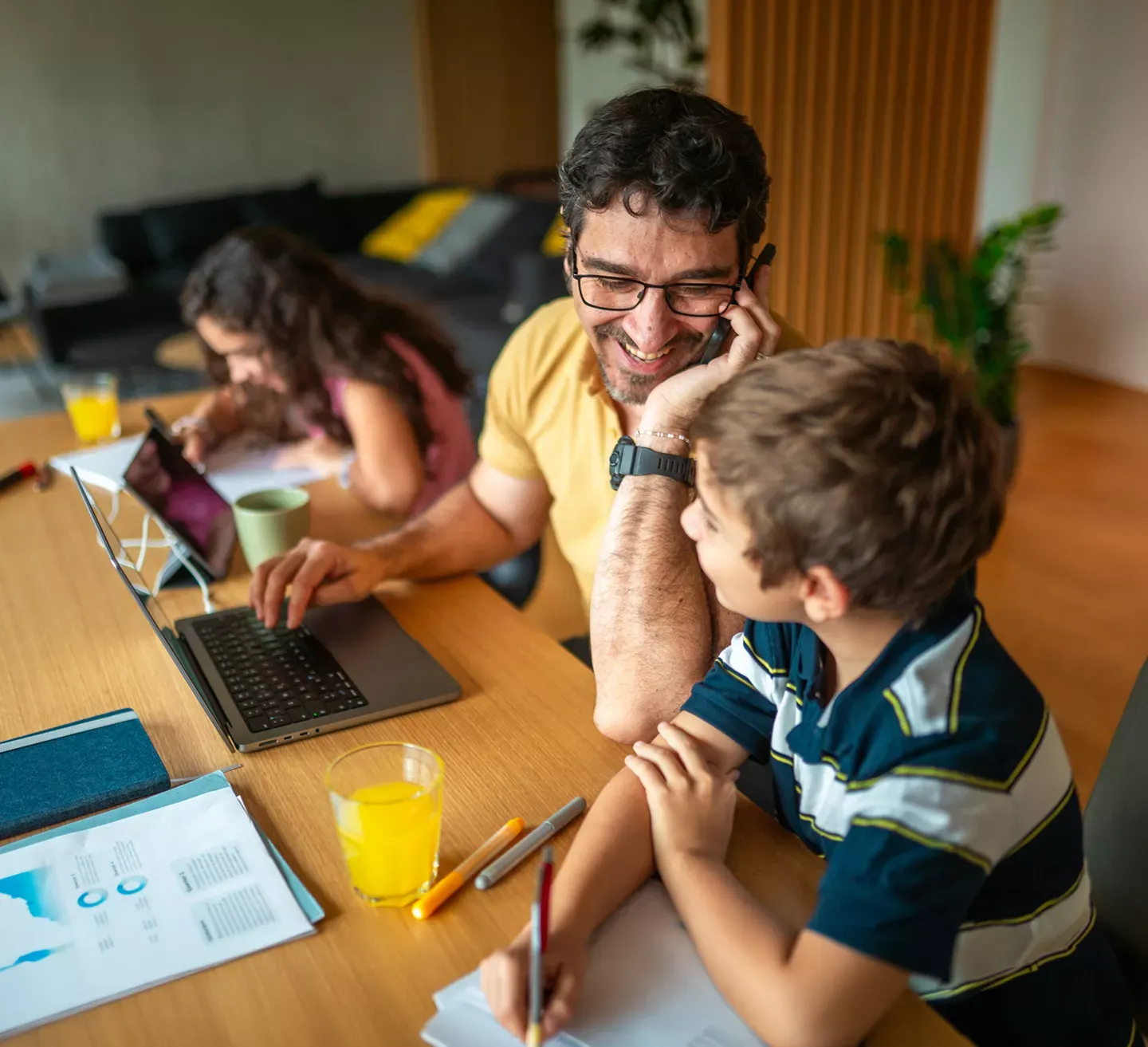Hispanic father and children use multiple devices with fiber internet at home