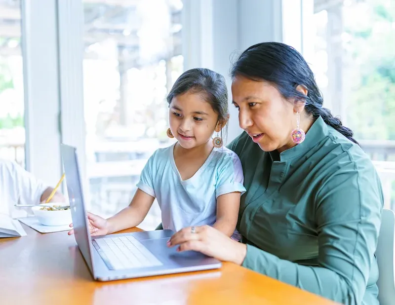 Mom and daughter using CenturyLink internet to do home work