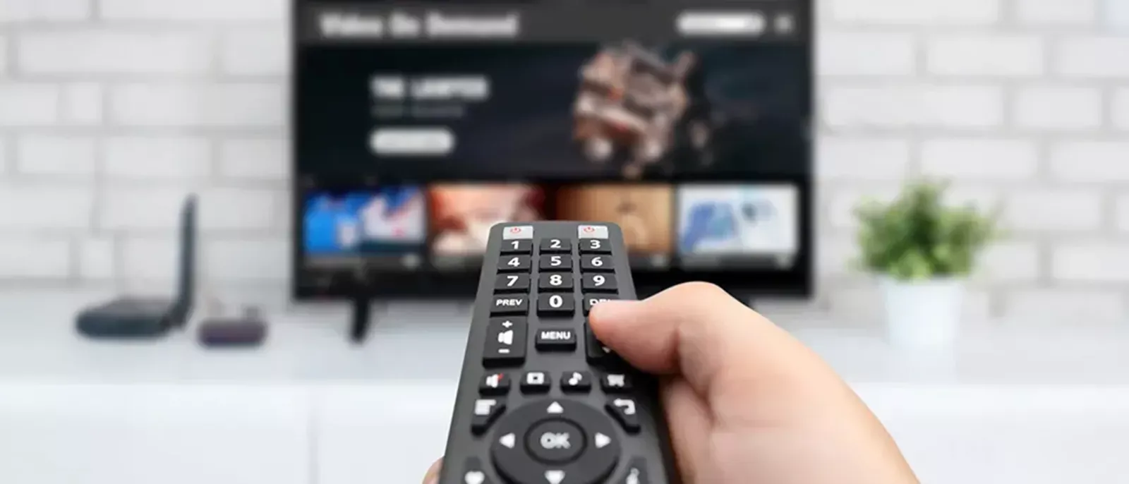 Remote control pointed towards TV with DISH