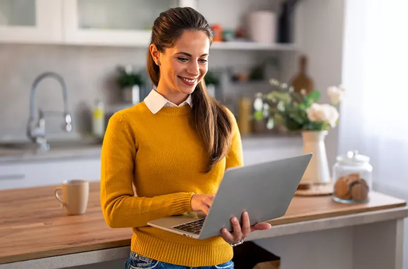 Woman smiling and using the internet.