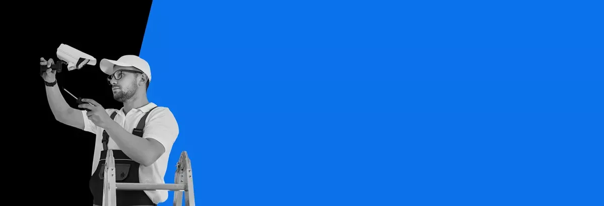 man installing a security camera