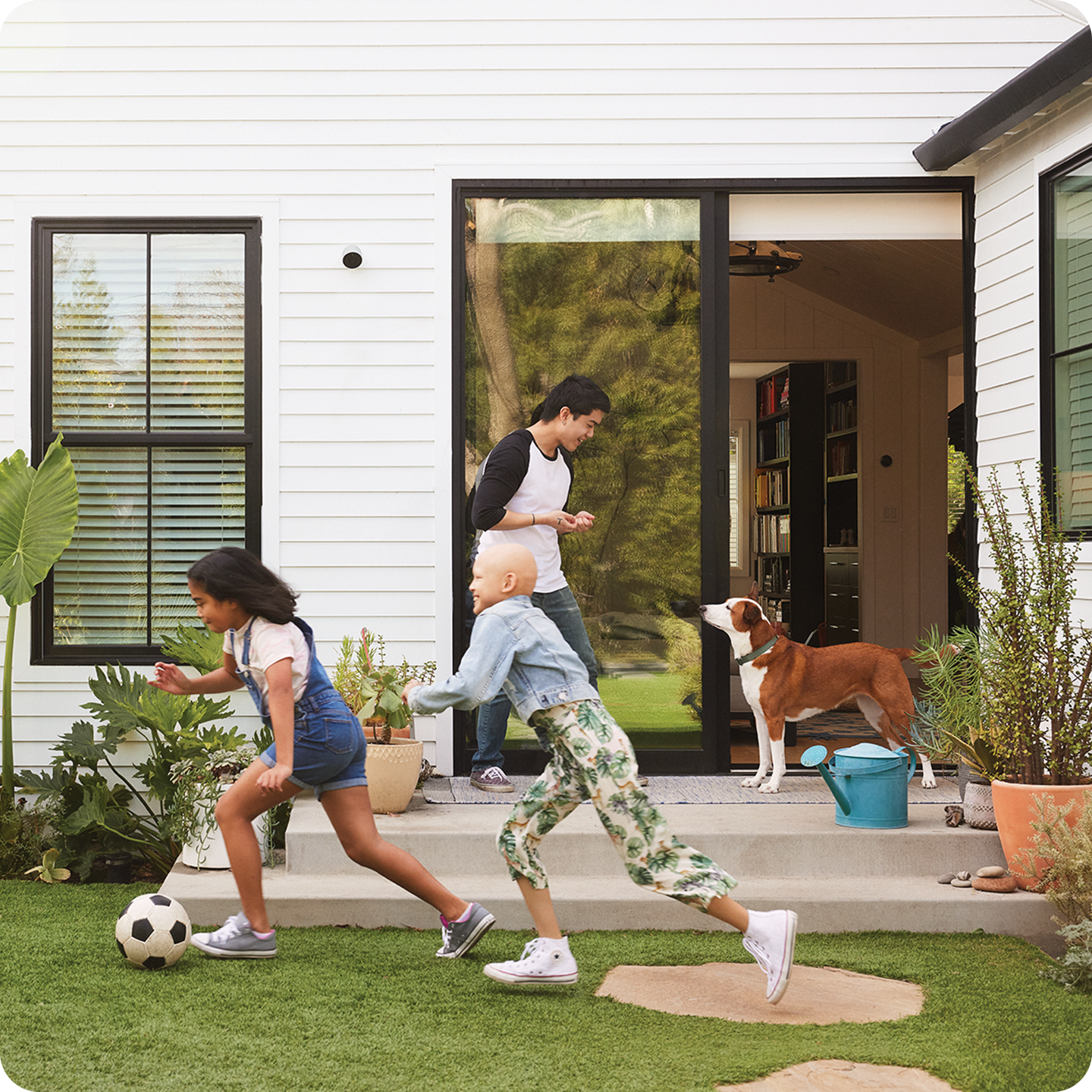 kids playing soccer in a back yard protected by ADT security