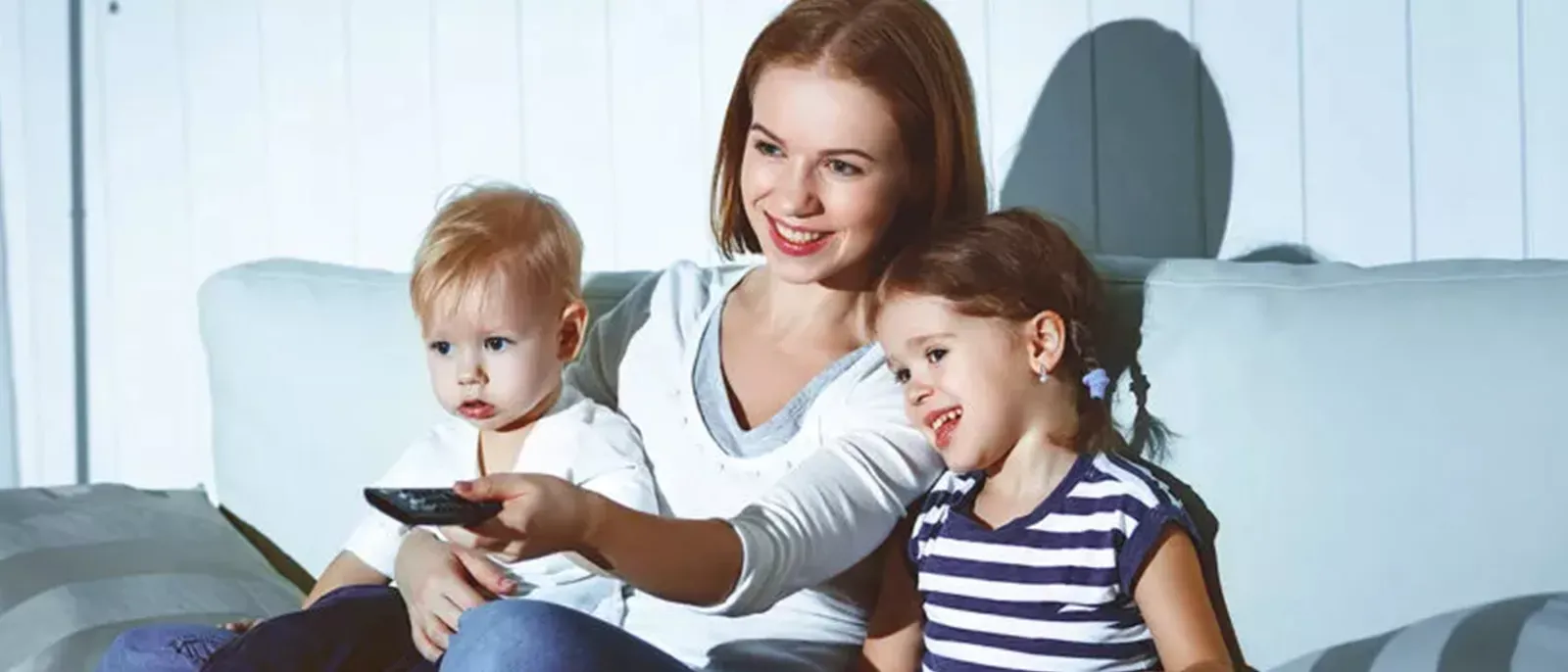 Mother and children watch TV shows