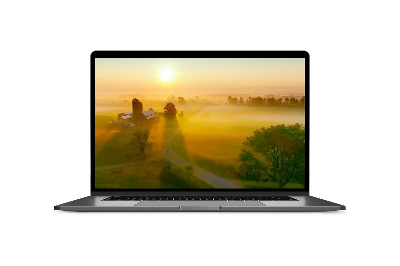 laptop with an image of a farm at sunset