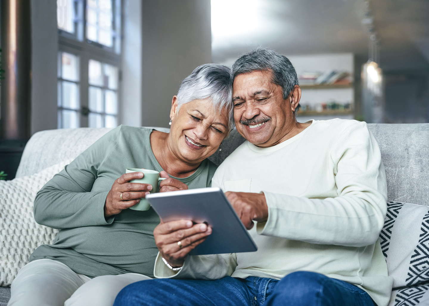 latino couple using CenturyLink internet to watch a video on a tablet device