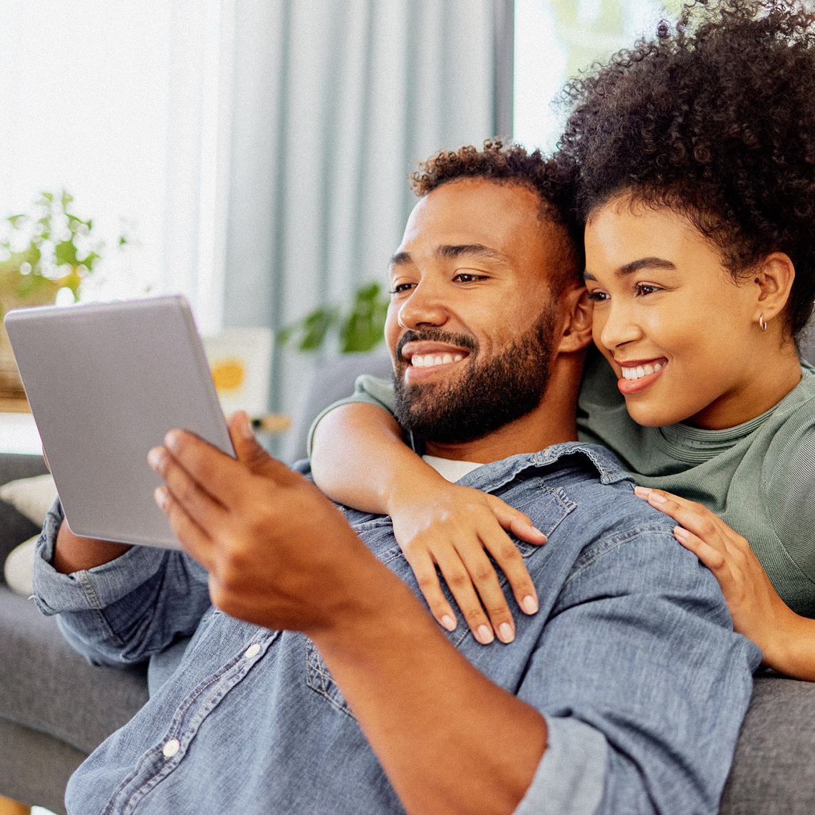 man and woman looking at tablet