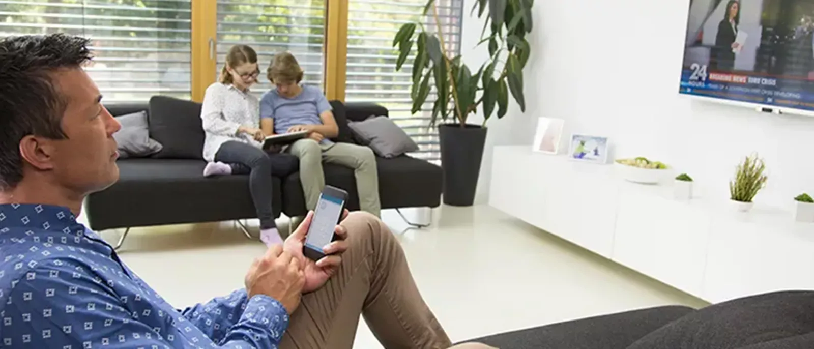 Man contemplating while watching TV