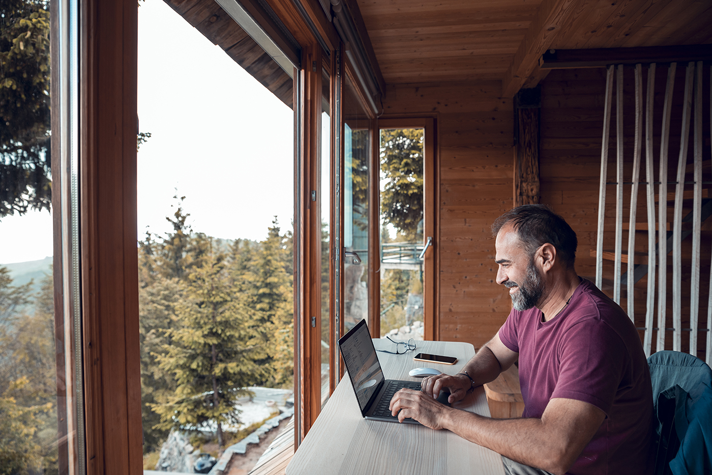man using internet on laptop in rural location