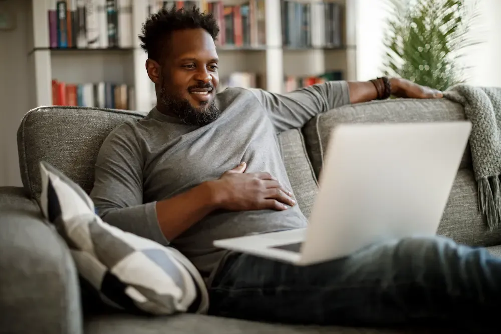Man using laptop on couch