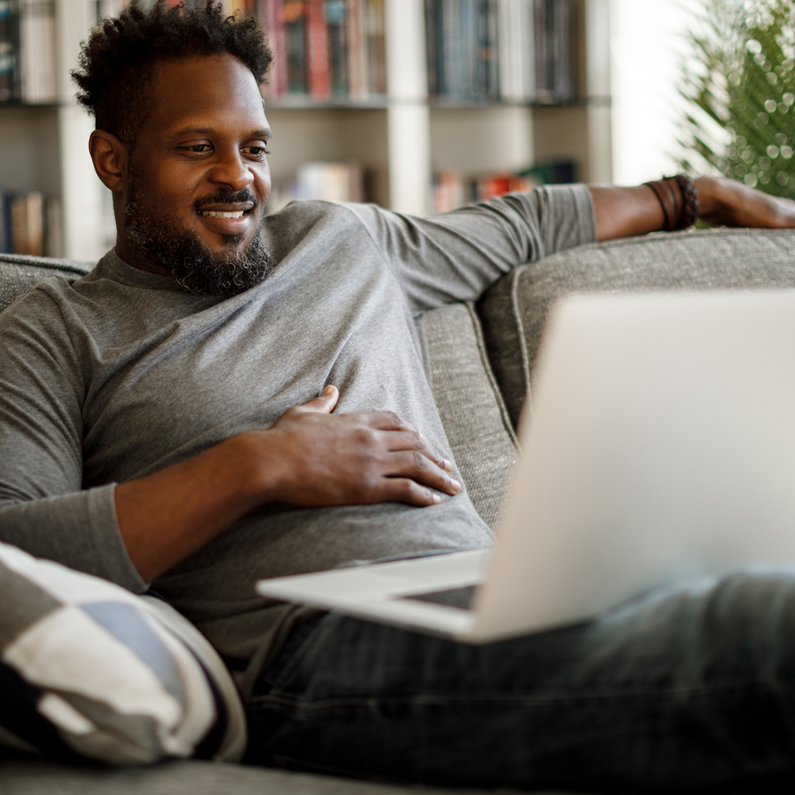 Man using laptop on couch