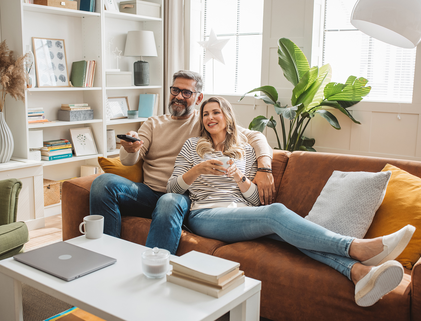mature couple watching a movie on a couch