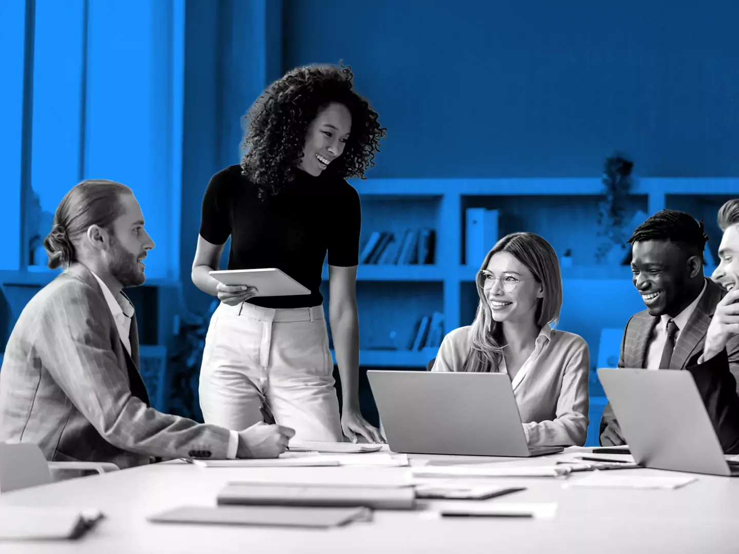 Working professionals working in a meeting room.