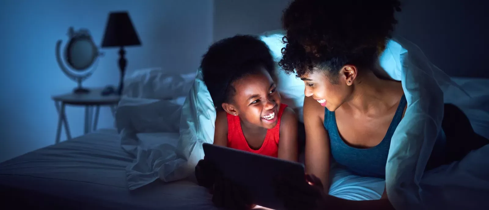 Mom and daughter enjoying some tablet streaming together.
