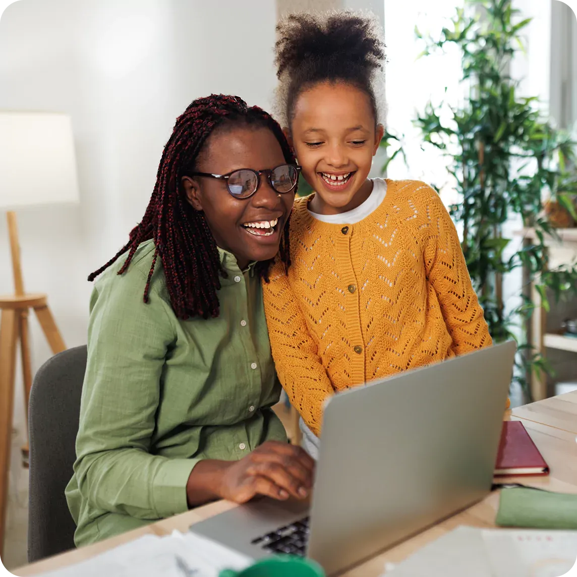 mother and daughter using laptop