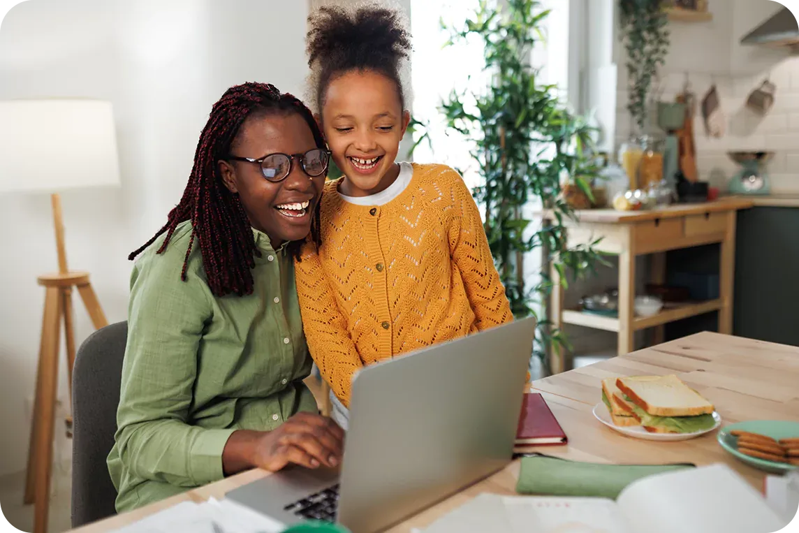 mother and daughter using laptop