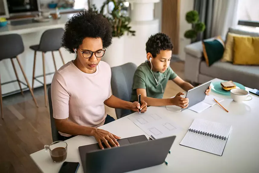 mother working from home and son using tablet