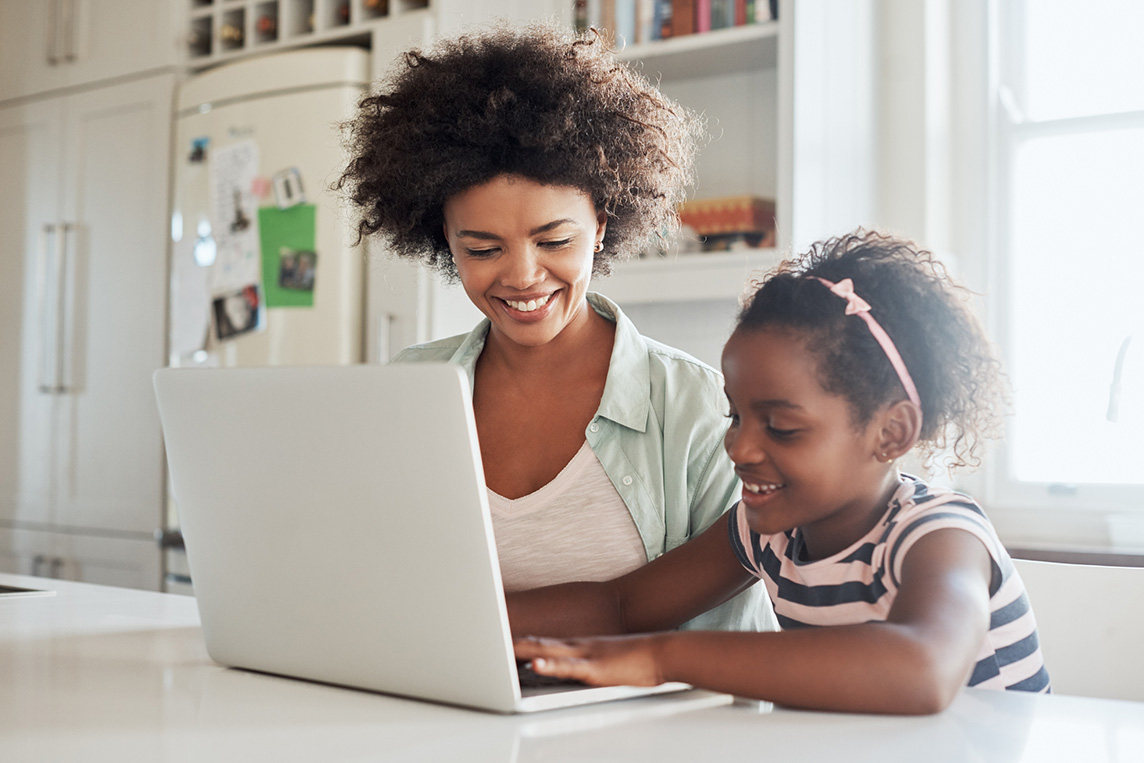 mother and daughter using a laptop