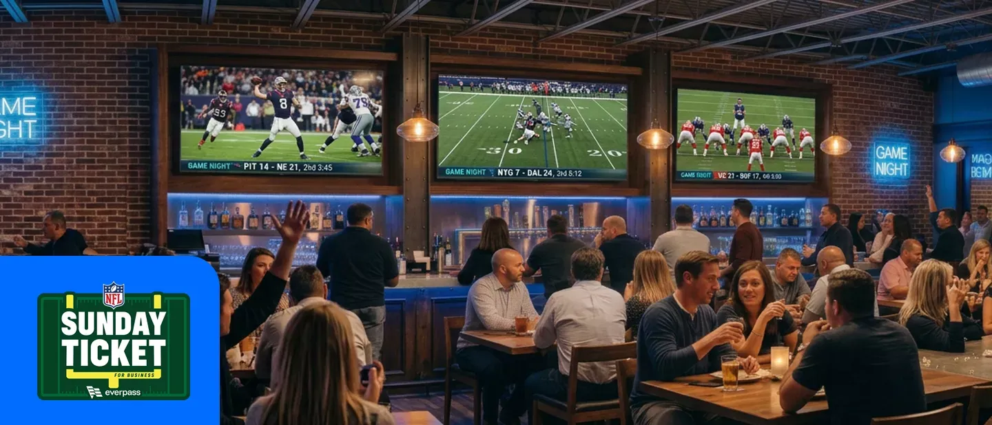 People gathered at a sports bar watching football games displayed on large televisions. Featuring the NFL sunday ticket everpass logo.