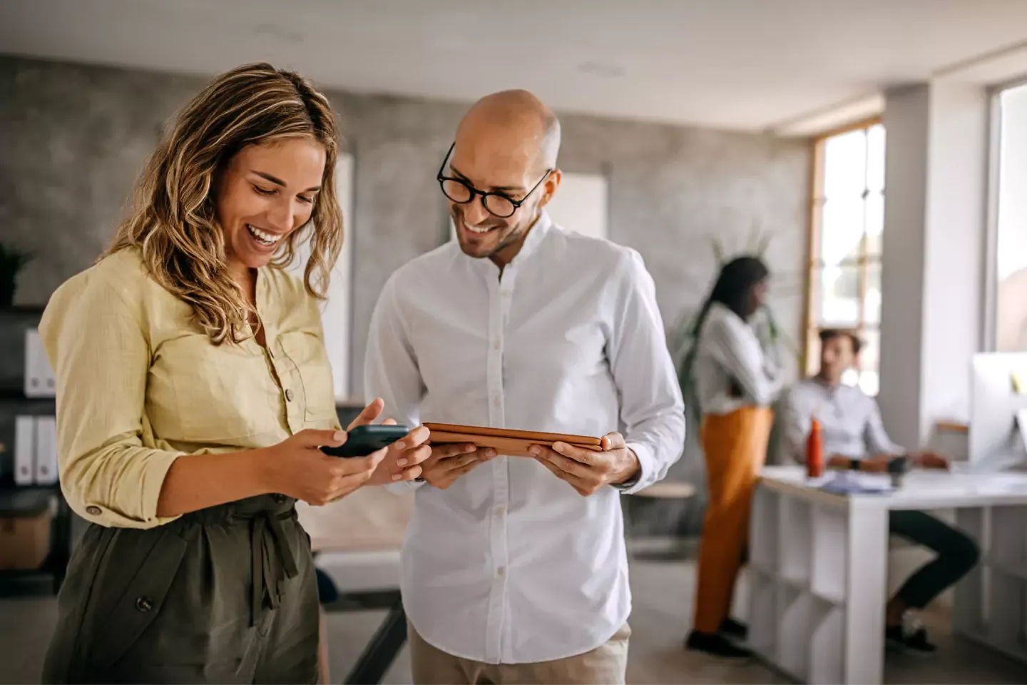 A couple of people using the internet at the office.