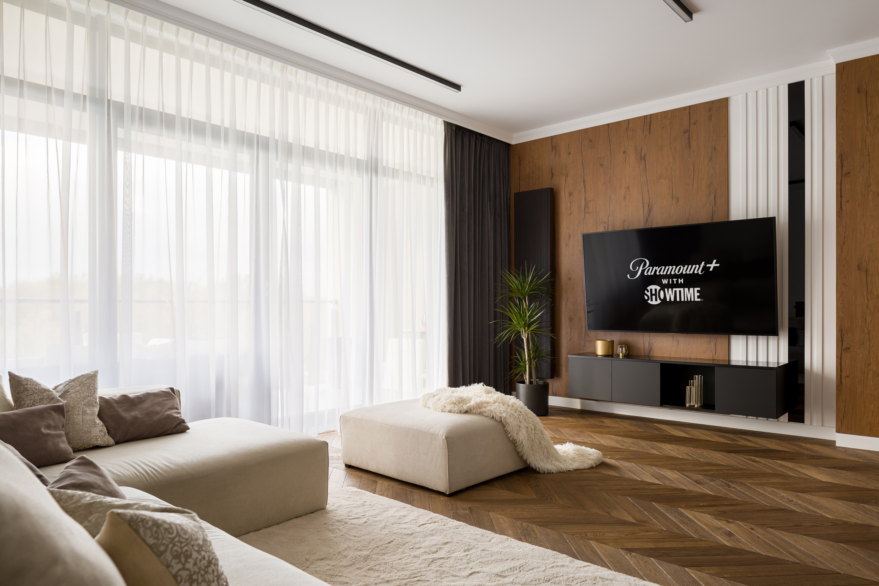 modern living room with a TV showing the logo of Paramount + with Showtime