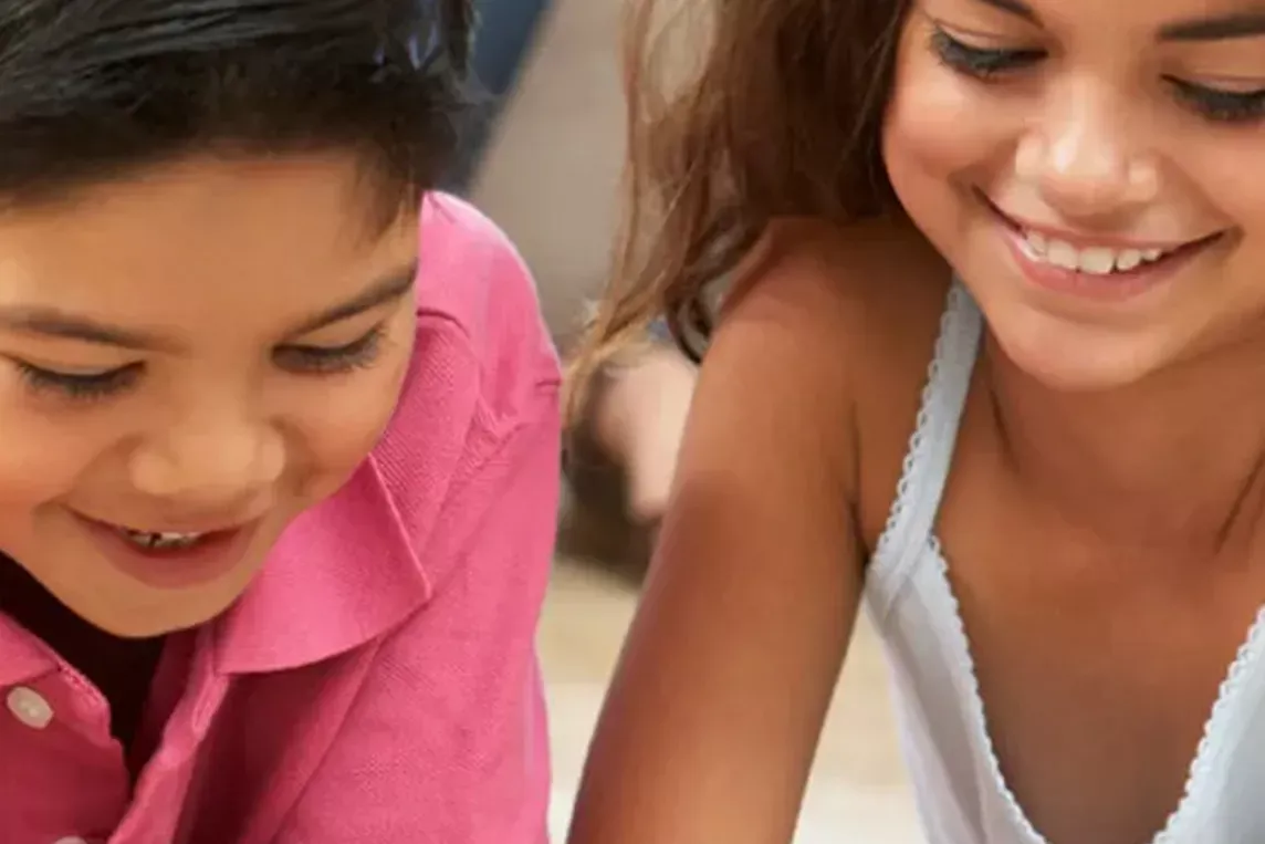 Two kids play together at home