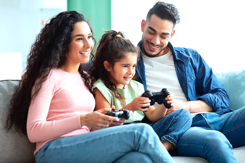 parents and daughter playing video games