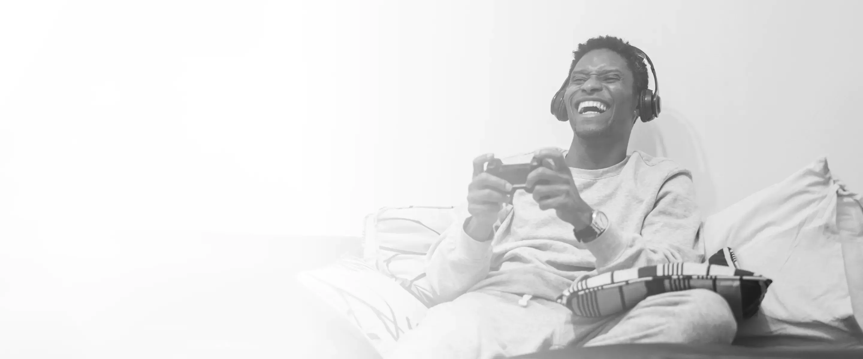 man playing video games on couch