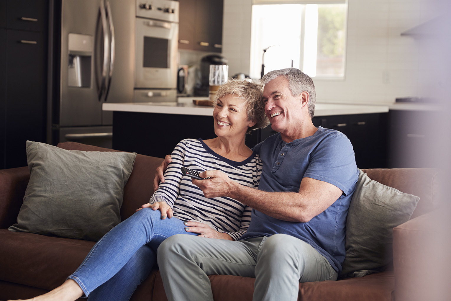 Senior couple watching tv on couch