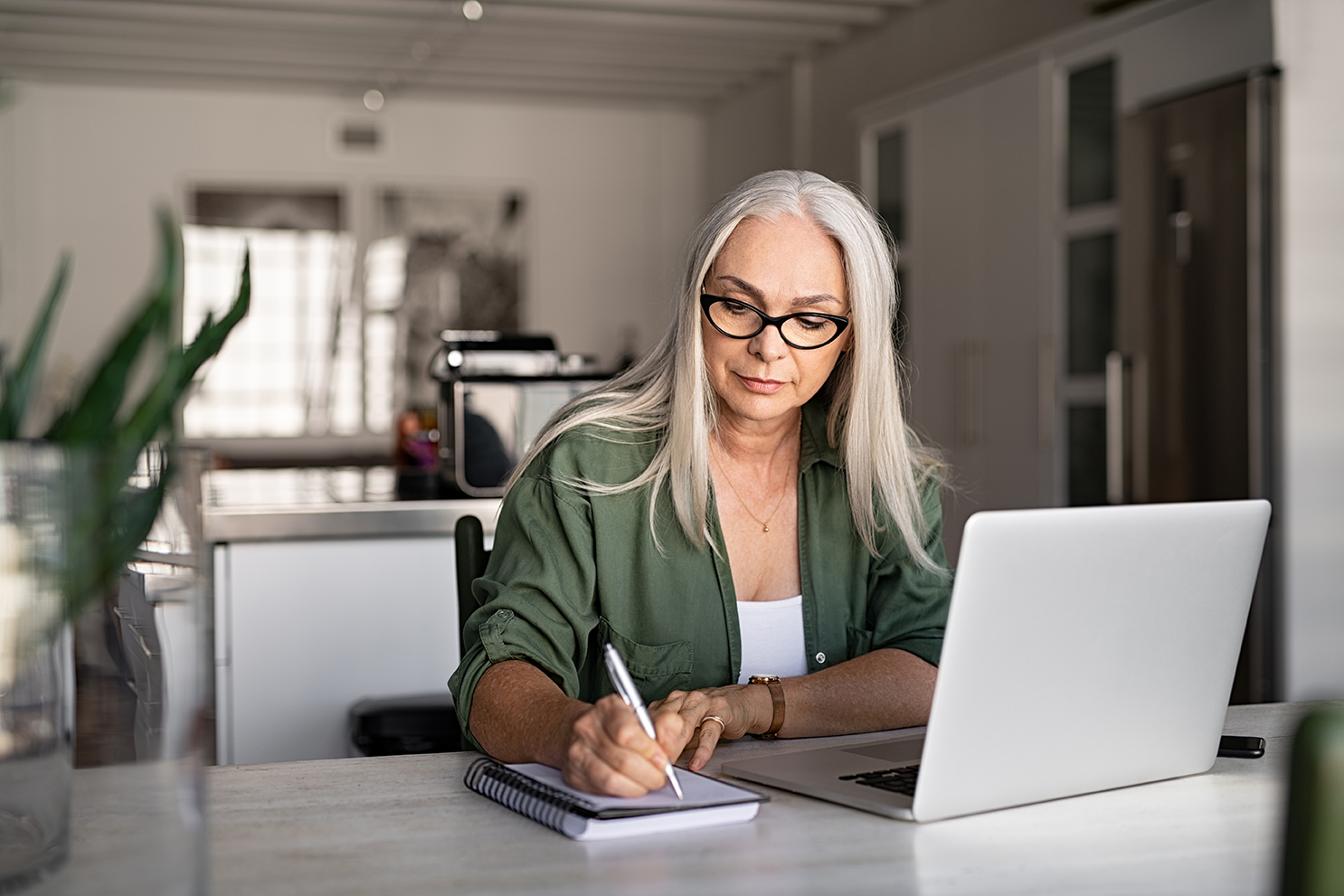 woman at computer writing notes