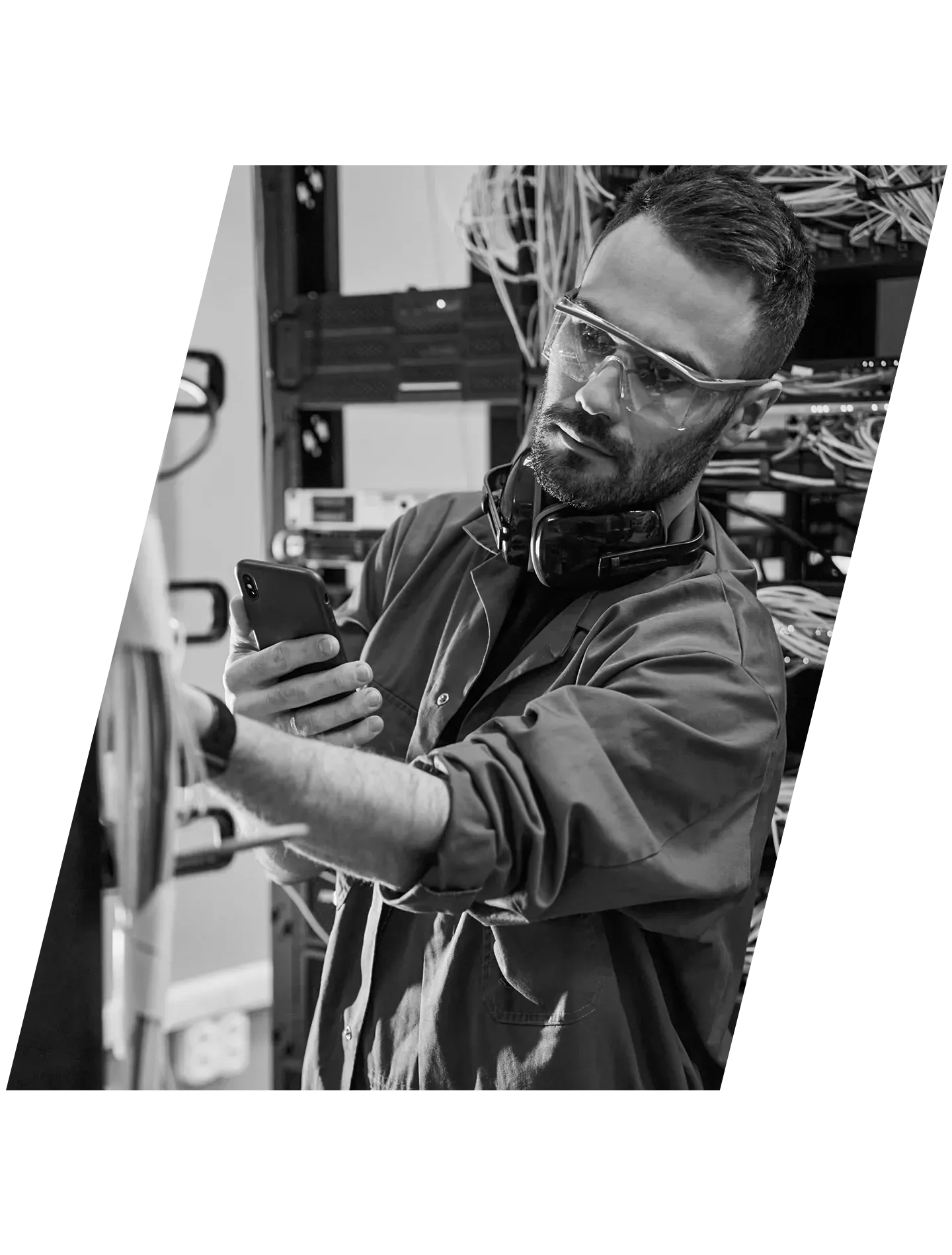 a technician working on cables in a server room