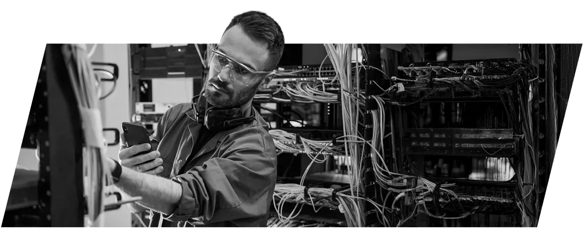 a technician working on cables in a server room