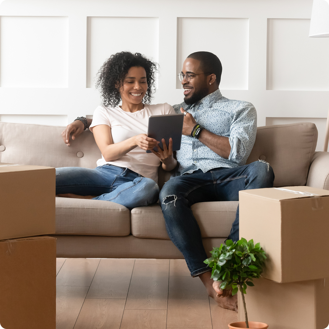 Couple sitting on couch with tablet