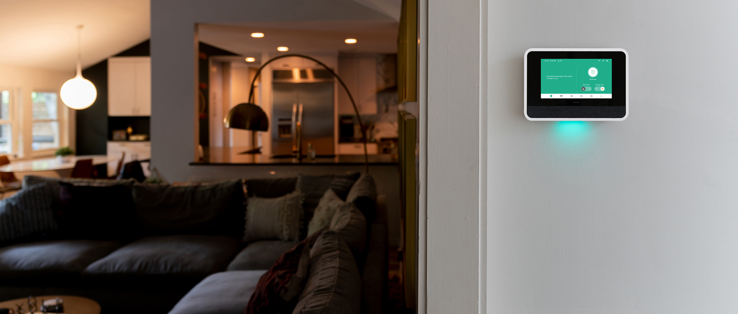Vivint Smart hub in a hallway looking into a modern living room