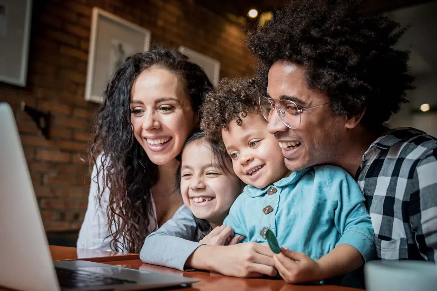 family at table video conferencing on computer