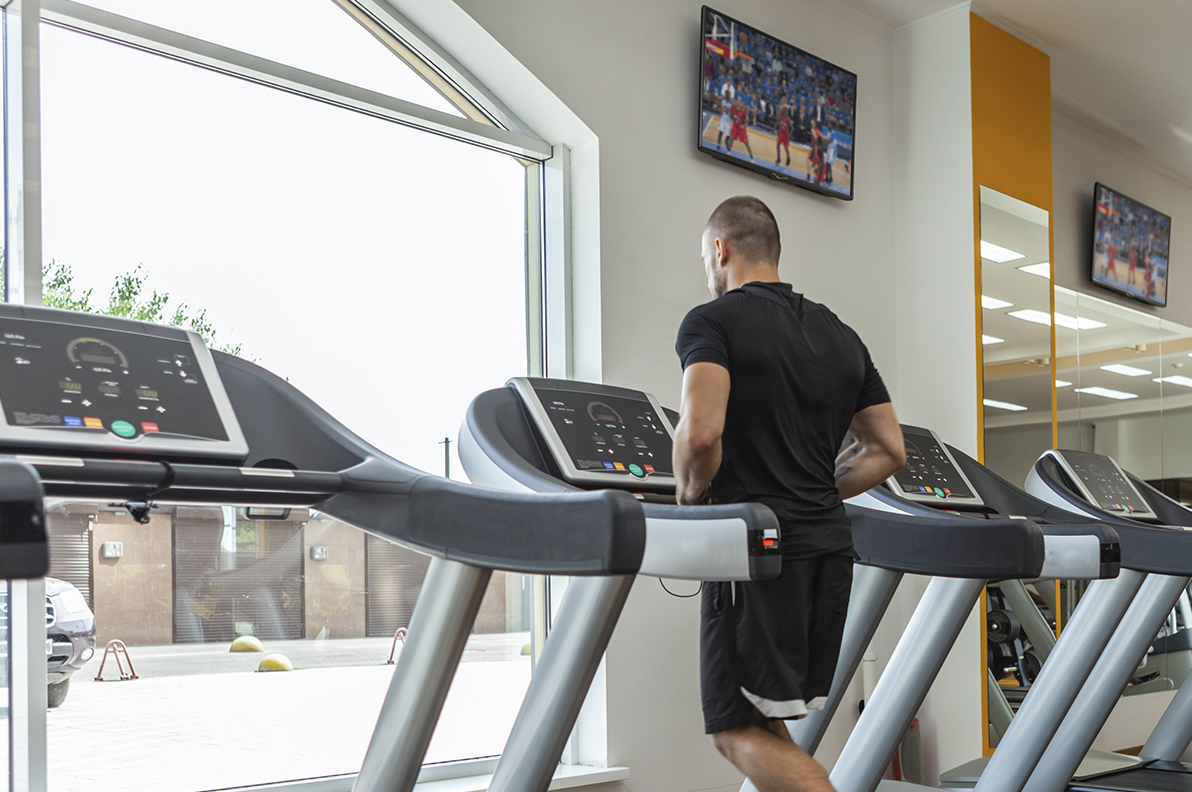Man running on treadmill at the gym