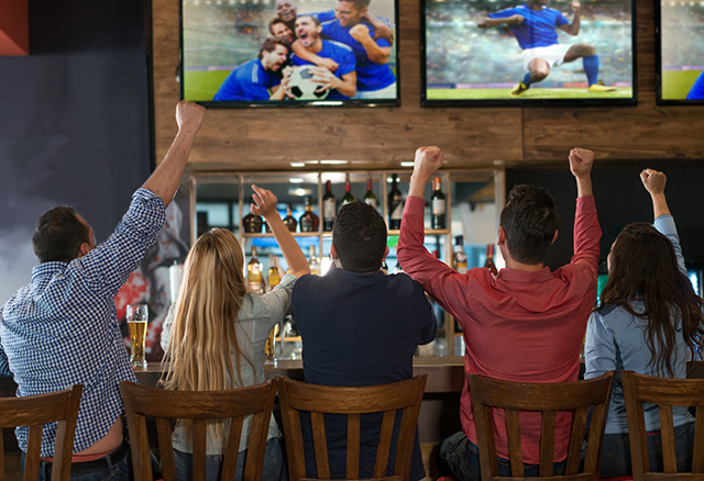 sports fans watching game on direct tv for business