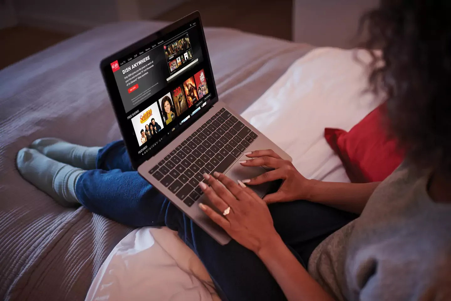 Woman streaming her favorite shows from dish on her laptop.