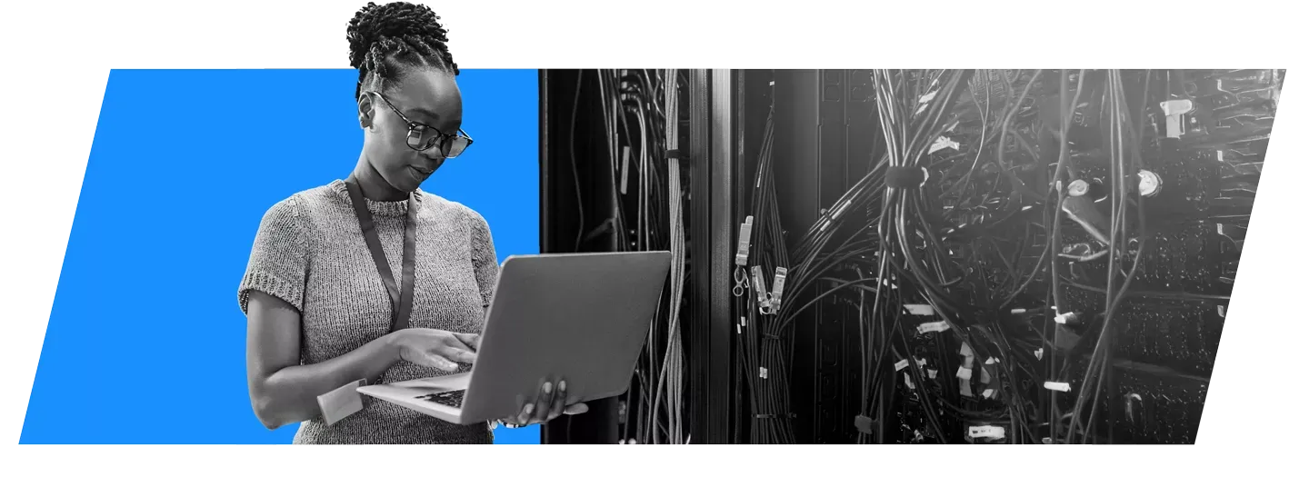 woman in a server room with laptop
