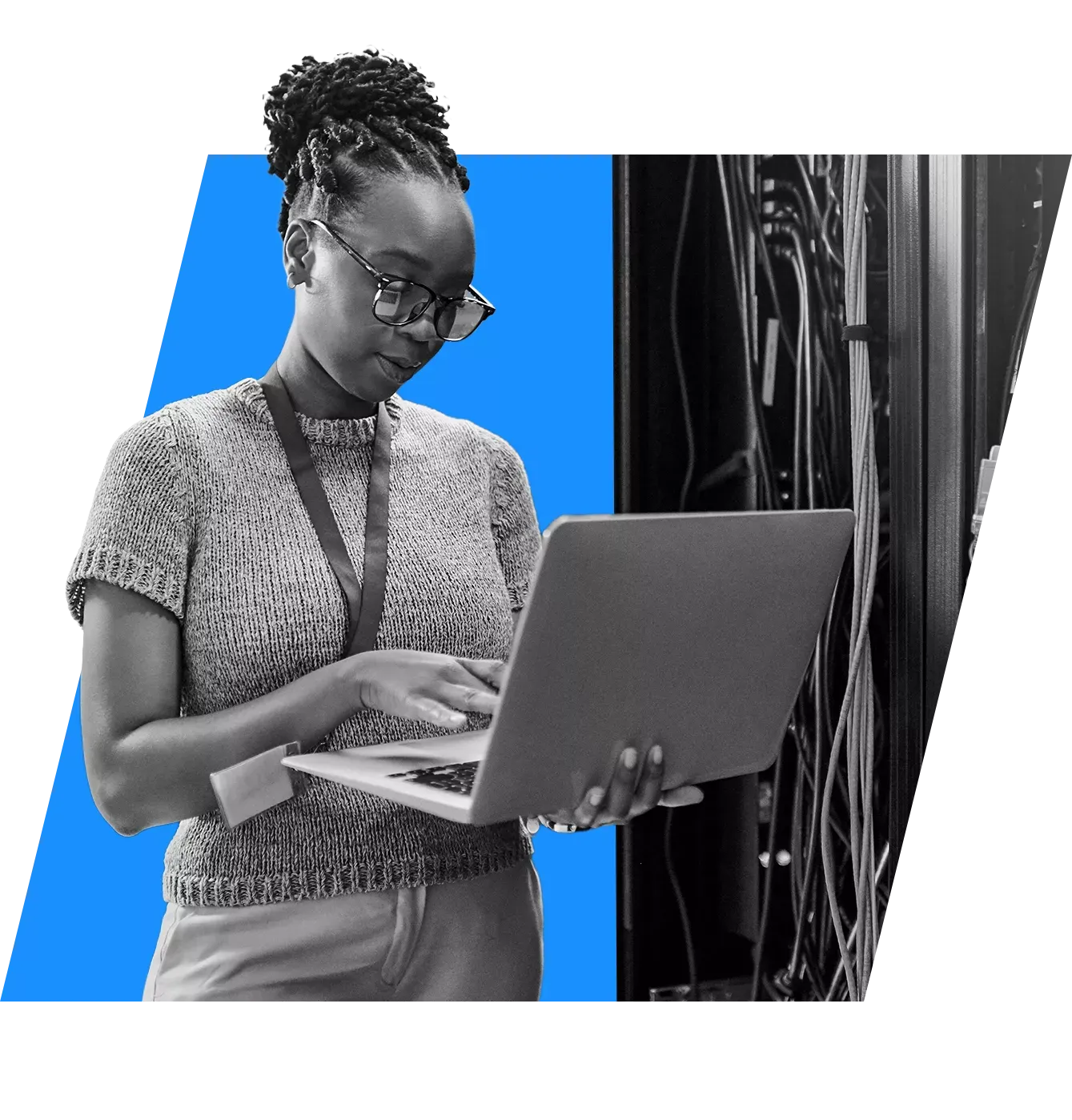 woman in a server room with a laptop