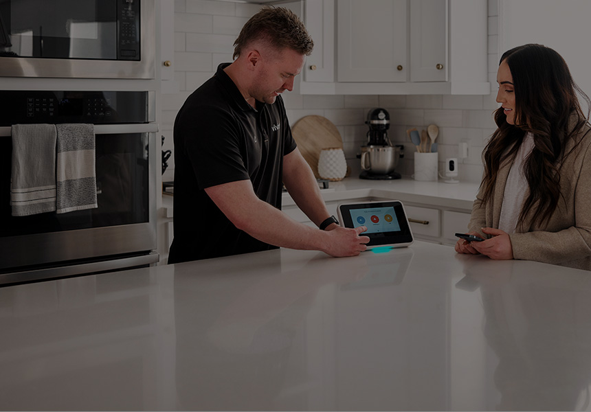 Vivint rep showing customer how to use Smart hub