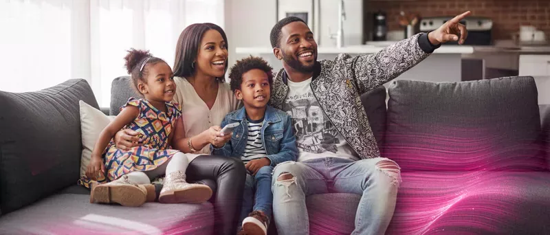 Happy Family watching Streaming their favorite shows with their fiber fast internet.