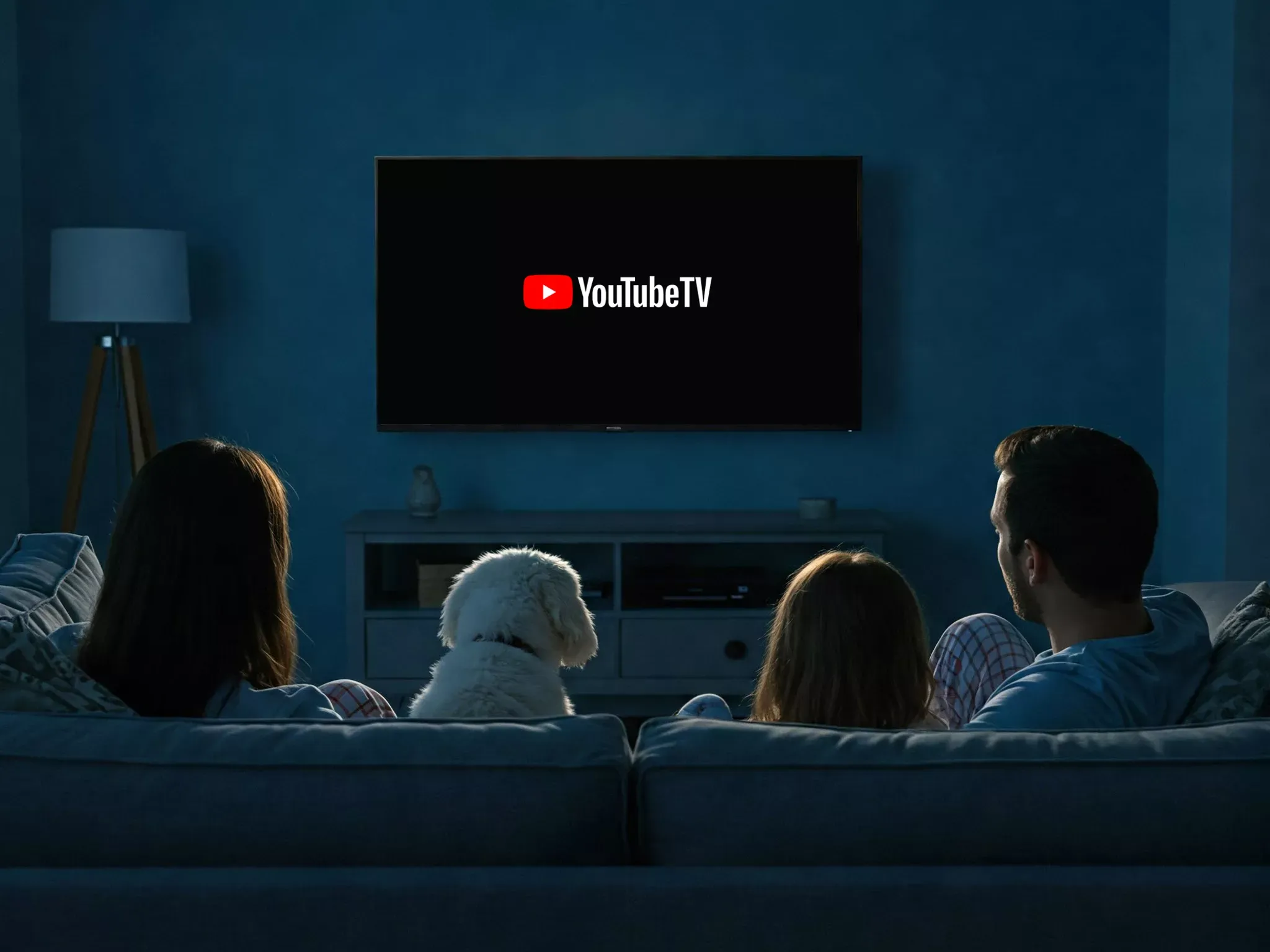 Family and Dog watching youtube TV, in the dark.