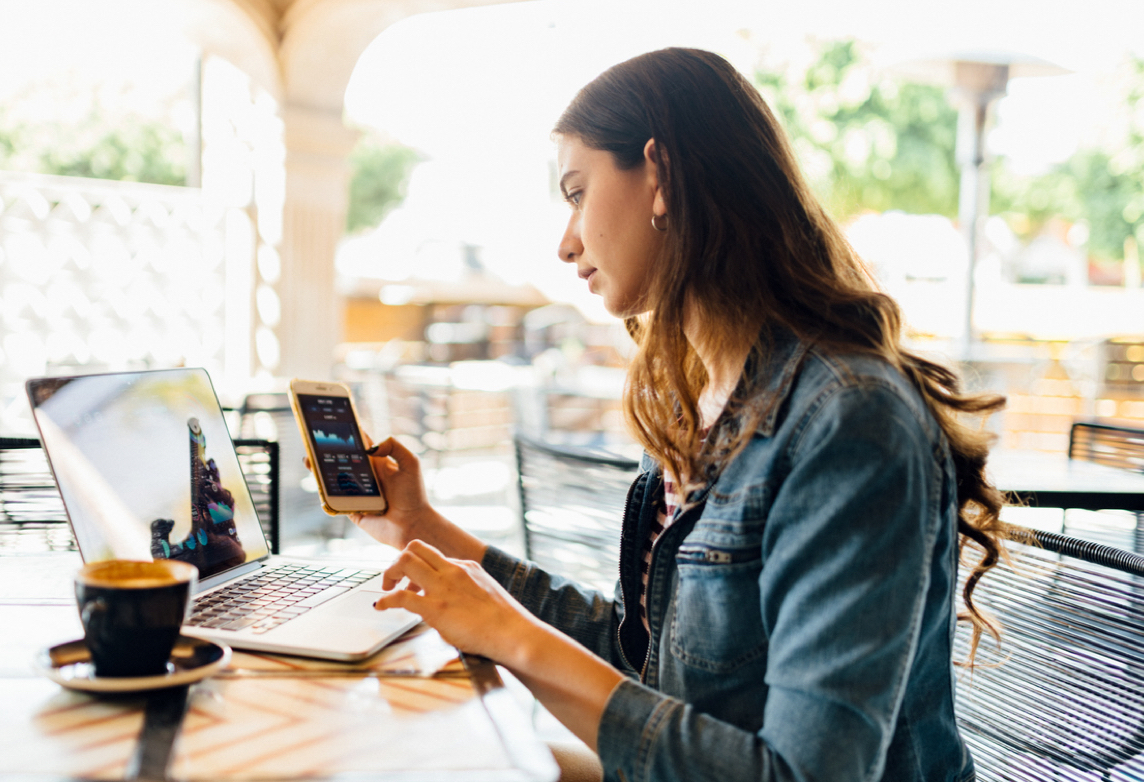 Woman uses hotspot for internet at cafe.