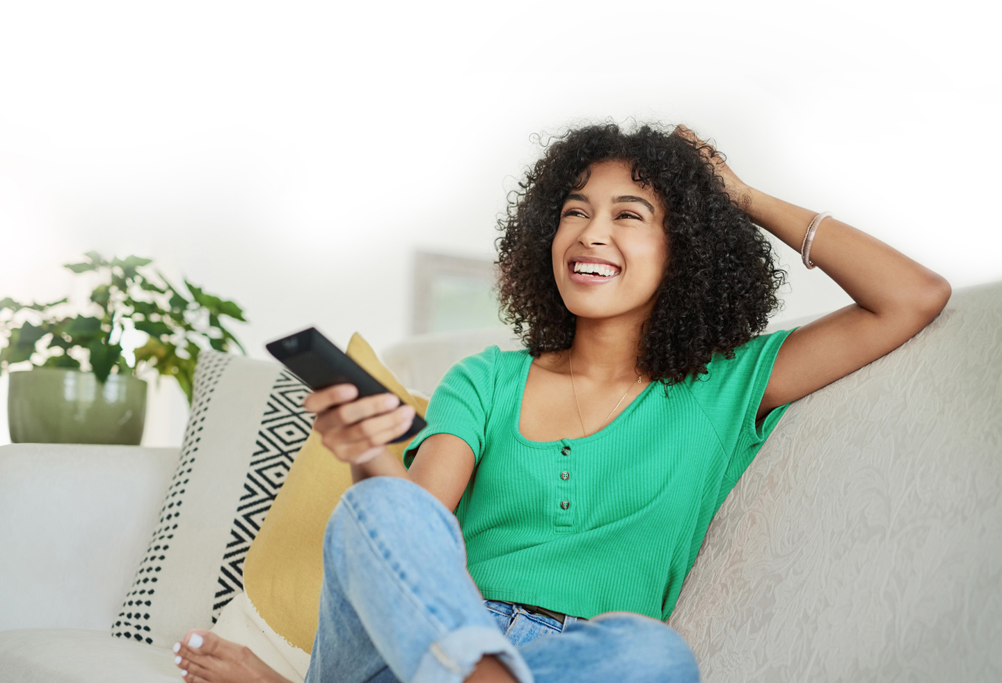 Woman in green shirt on couch watching tv