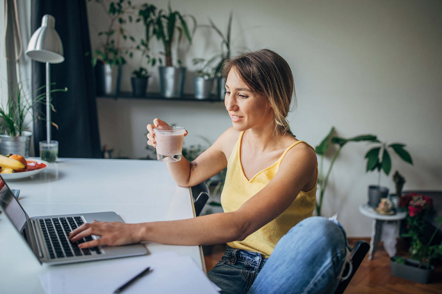 woman at table using laptop