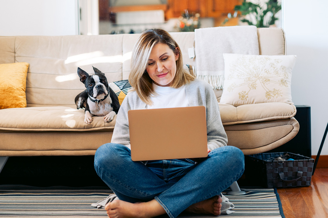 Woman browsing internet with dog