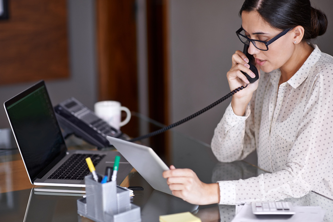 woman using AT&T business phone and internet
